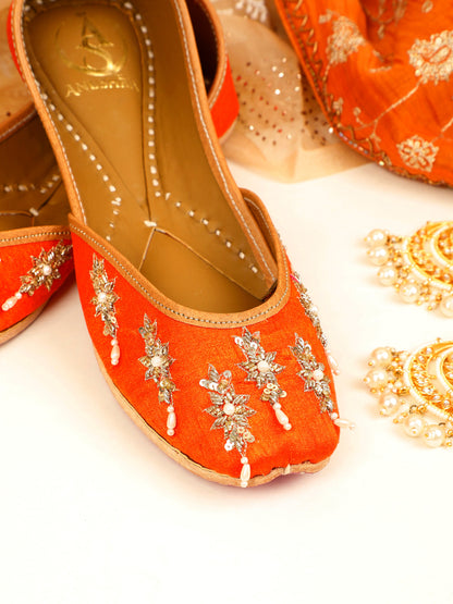 Saffron orange embellished ethnic flats for women – top product view